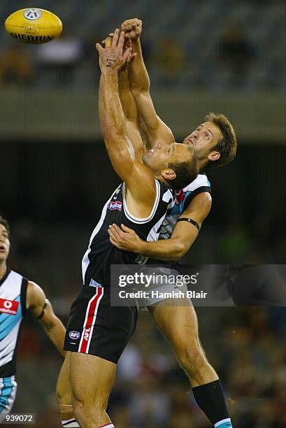 Stewart Loewe for St Kilda has the ball fisted away by Darryl Wakelin for Port Adelaide, during the Round 3 AFL Match between the St Kilda Saints and...