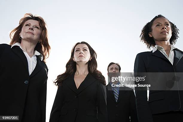 businesspeople looking up - group of businesspeople standing low angle view stock pictures, royalty-free photos & images