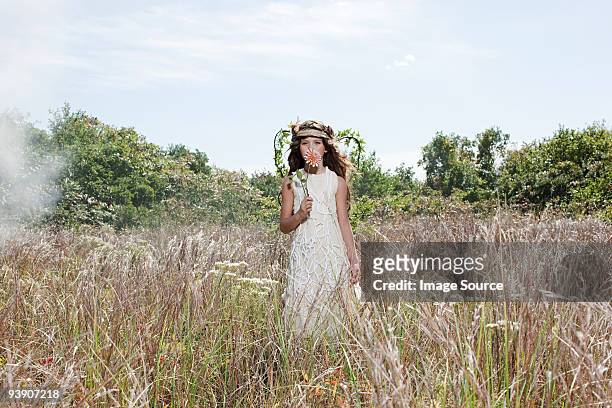 girl dressed as fairy in field with flower - angel dust stock pictures, royalty-free photos & images