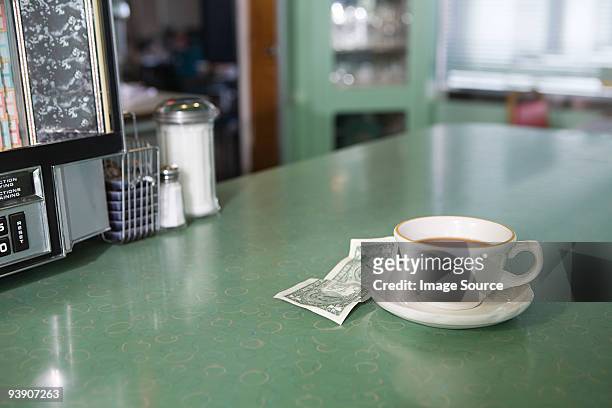 coffee and money on a diner counter - usa diner stock pictures, royalty-free photos & images