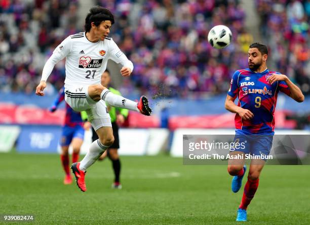 Kazuki Oiwa of Vegalta Sendai and Deigo Oliveira of FC Tokyo compete for the ball during the J.League J1 match between FC Tokyo and Vegalta Sendai at...