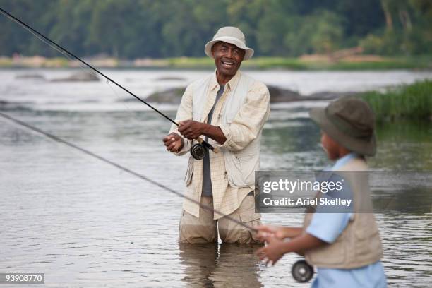 african grandfather and grandson fishing - virginia amerikaanse staat stockfoto's en -beelden