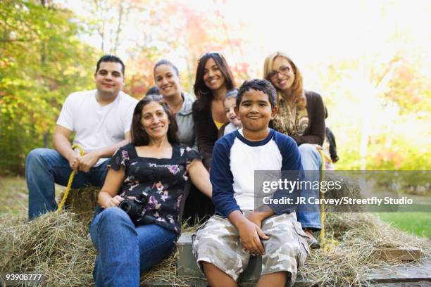 adults and children sitting on hay ride - hayride foto e immagini stock