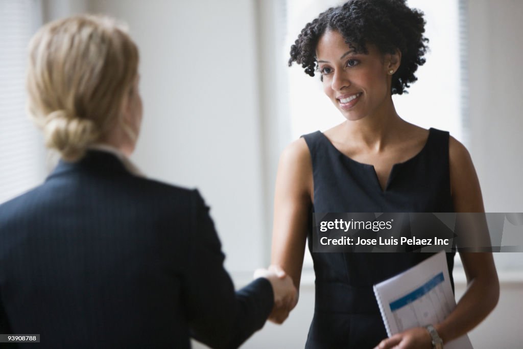 Businesswomen shaking hands