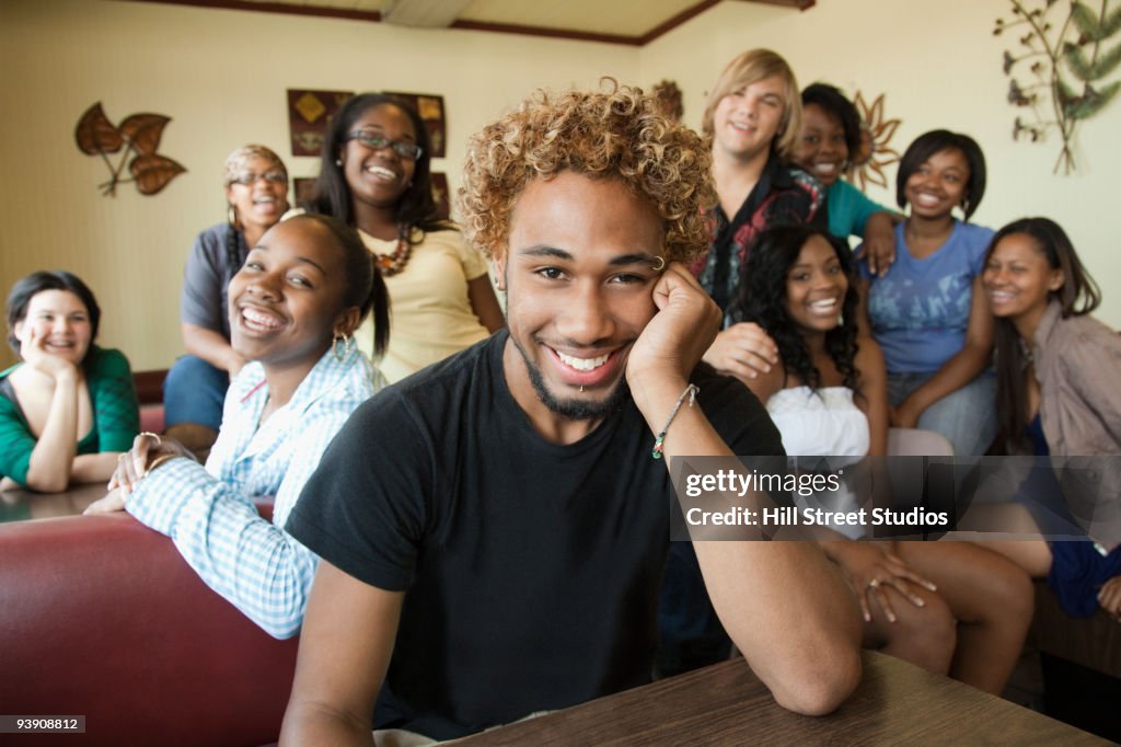 Young man in diner with group of young women in background