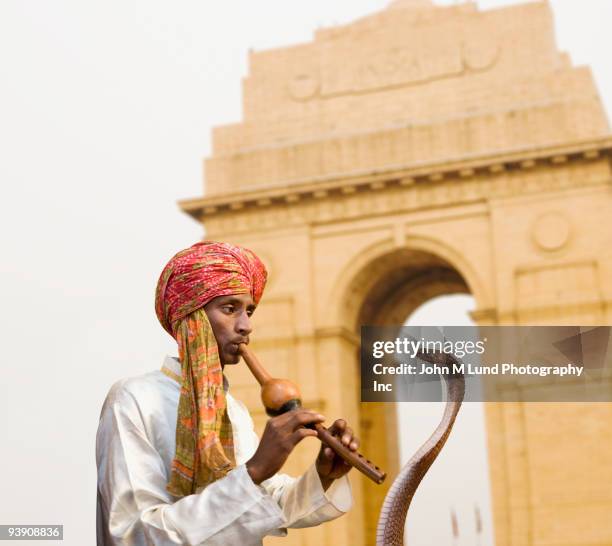 asian snake charmer playing flute - snake charmer stock pictures, royalty-free photos & images