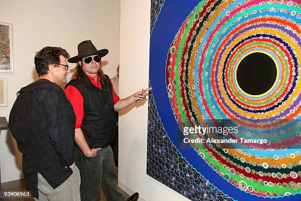 Artist Fred Tomaselli and actor Val Kilmer look at Tomaselli's piece "Big Eye" at Art Basel Miami at the Miami Beach Convention Center on December 4,...