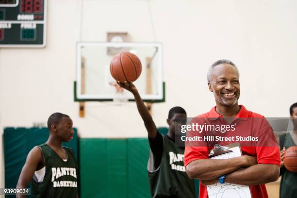 african coach and basketball players in gym - basketball teamwork stock pictures, royalty-free photos & images