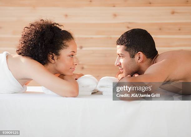 couple laying face to face on massage table - girlfriend massage stock pictures, royalty-free photos & images