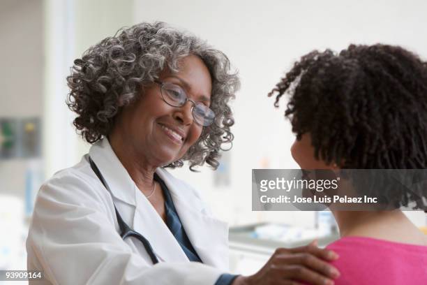 african doctor greeting patient - prop stock pictures, royalty-free photos & images