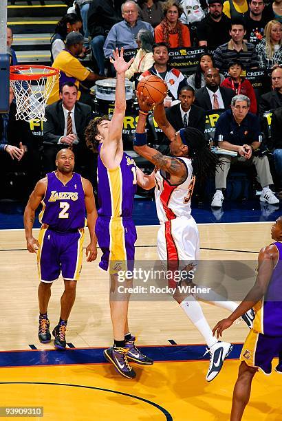 Mikki Moore of the Golden State Warriors goes to the basket against Pau Gasol of the Los Angeles Lakers during the game on November 28, 2009 at...