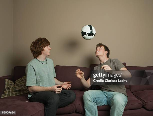 boys playing football indoors - two guys playing soccer stockfoto's en -beelden