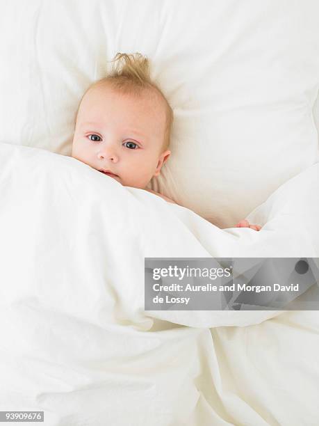 baby in bed - david de lossy sleep stock pictures, royalty-free photos & images