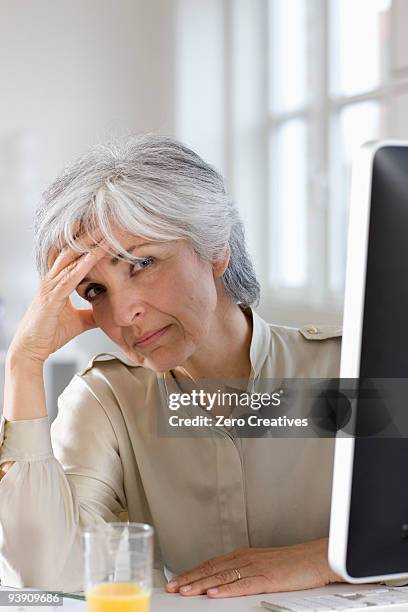 woman working in an office - overdoing stock pictures, royalty-free photos & images