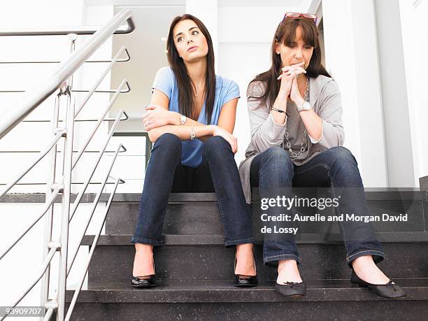 women on stairs - mom head in hands stock pictures, royalty-free photos & images