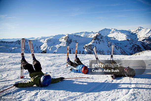 three children lying in the snow. - mount disappointment stock pictures, royalty-free photos & images