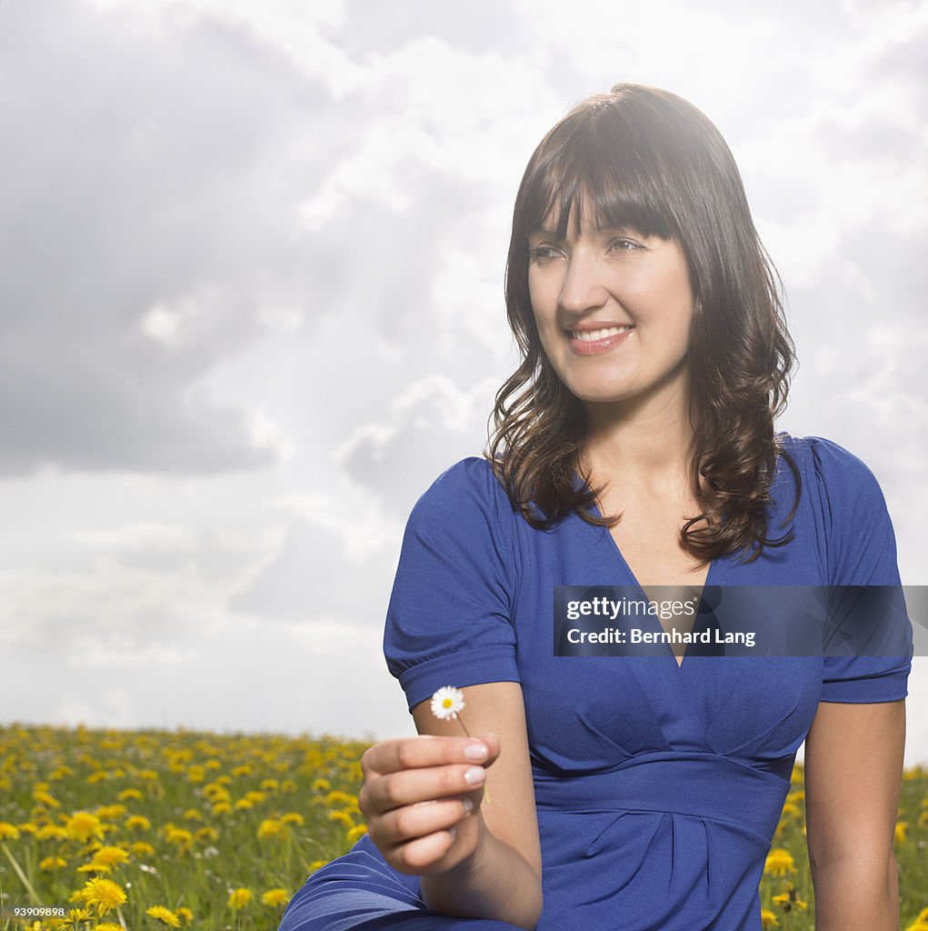 Woman sitting on meadow