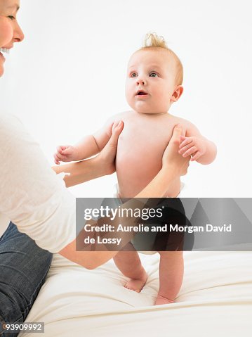 Baby Getting Help Baby Standing With Help High-Res Stock Photo - Getty Images