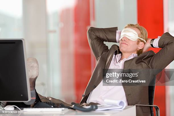 man has a break in an office - computer wearing eye mask stock pictures, royalty-free photos & images