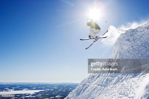 man in green getting air-time. - downhill skiing stock pictures, royalty-free photos & images