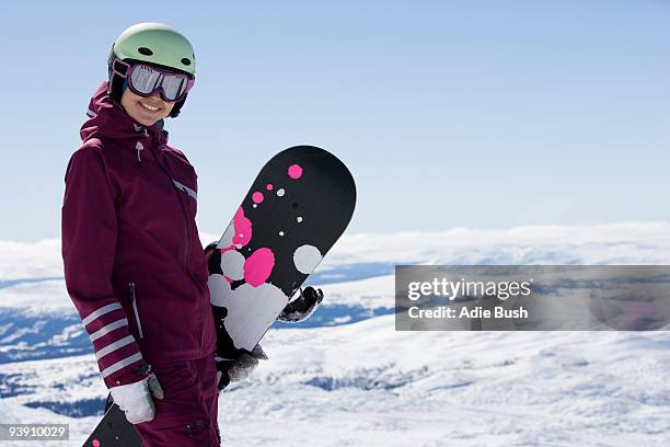 girl posing with snowboard. - women snowboarding stock pictures, royalty-free photos & images