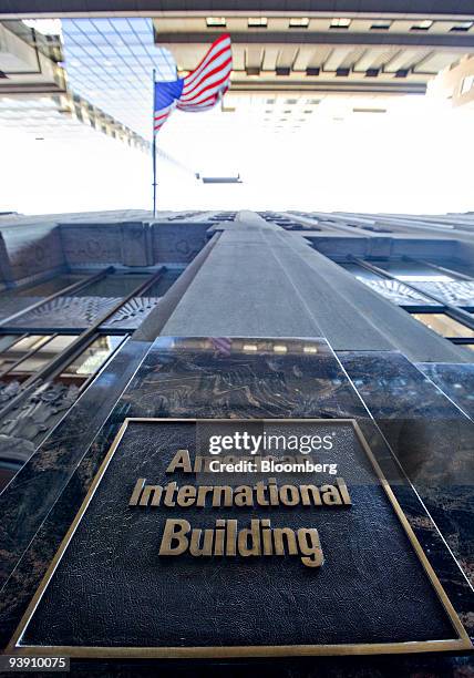 Flag flies outside 70 Pine Street, home to the headquarters of American International Group , in New York, U.S., on Friday, Dec. 4, 2009. U.S....