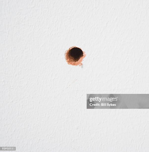 drilled hole in wall - hole foto e immagini stock