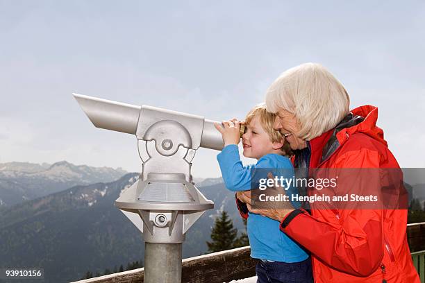 boy, grandma looking through telescope - mensch fernrohr stock-fotos und bilder