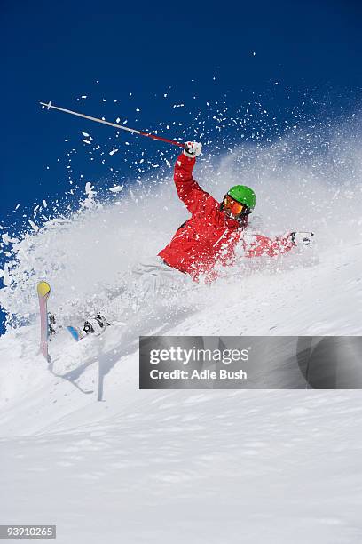 man in red falling mid carve off-piste. - wipeout stock pictures, royalty-free photos & images