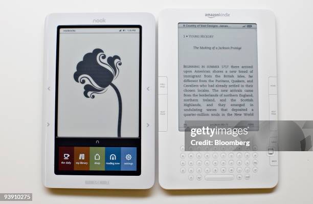 The Barnes & Noble Nook electronic book reader, left, and the Amazon.com Kindle 2 ebook reader are displayed for a photograph in New York, U.S., on...