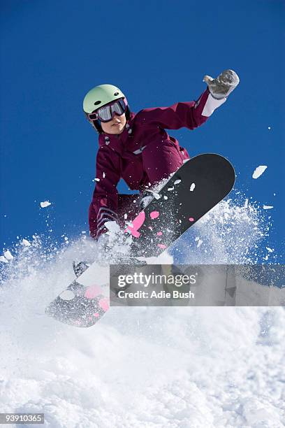 man grabbing her board mid air. - sweden snowboarding stock pictures, royalty-free photos & images