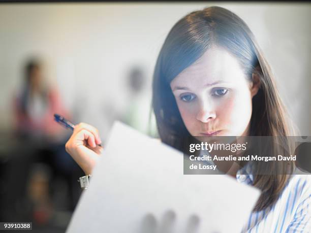 woman writing against window - confused writing ストックフォトと画像