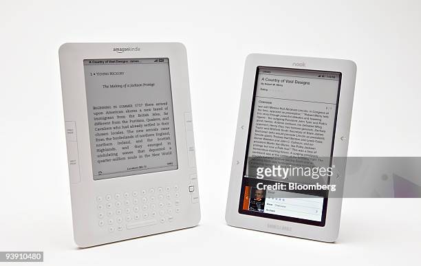 The Barnes & Noble Nook electronic book reader, right, and the Amazon.com Kindle 2 ebook reader are displayed for a photograph in New York, U.S., on...