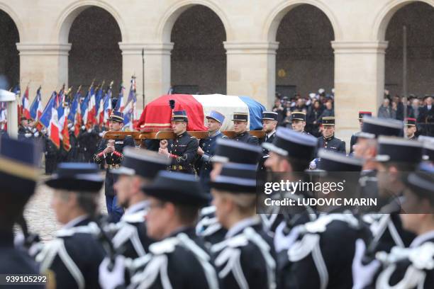 French Republican Guards and cadets from the joint-army military school carry the coffin of Lieutenant-Colonel Arnaud Beltrame during a national...
