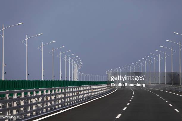Vehicle travels along a section of the Hong Kong-Zhuhai-Macau Bridge during a media tour of the bridge offshore in Zhuhai, China, on Wednesday, March...