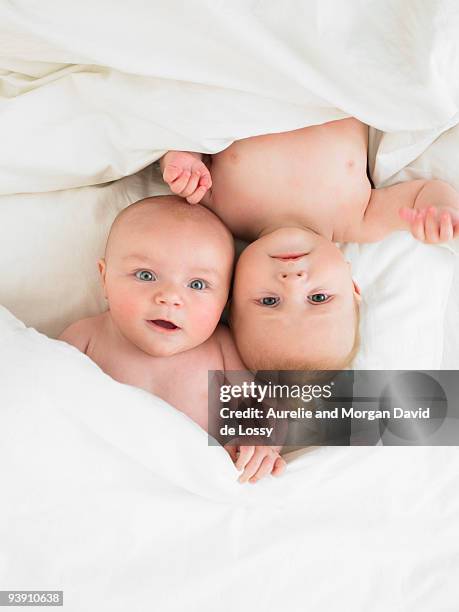 babies in bed - baby boy and girl stock pictures, royalty-free photos & images