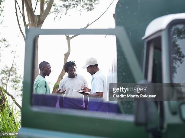 coffee workers with clipboard - jamaica coffee stock pictures, royalty-free photos & images