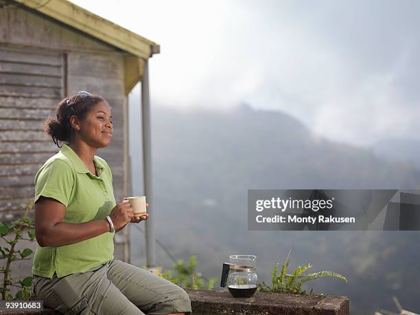female coffee worker drinking coffee - jamaica coffee stock pictures, royalty-free photos & images