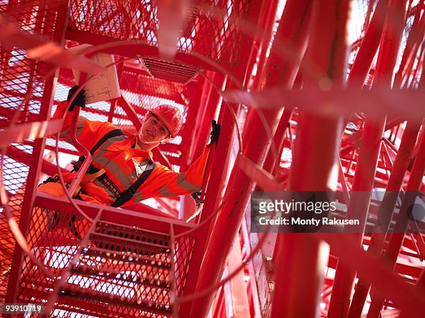 crane worker looking down from crane - untersicht stock-fotos und bilder