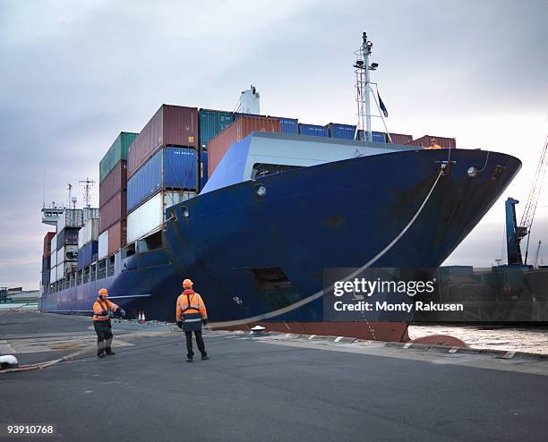 port workers with loaded ship at port - förtöjd bildbanksfoton och bilder