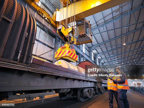 port workers loading cargo on to train - rail worker stock pictures, royalty-free photos & images