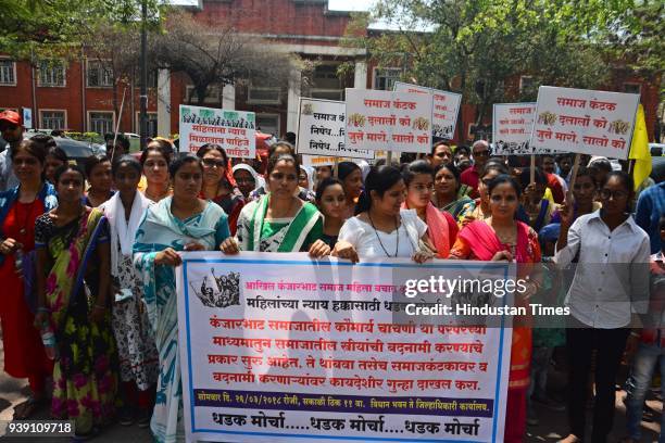 Kanjarbhat community members, in support of the virginity ritual, held a protest march from the Vidhan Bhavan to collectorate by holding pla cards...