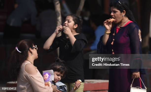 People having ice cream on a hot afternoon at Bandstand, on March 26, 2018 in Mumbai, India. After a week of pleasant weather, the scorching summer...