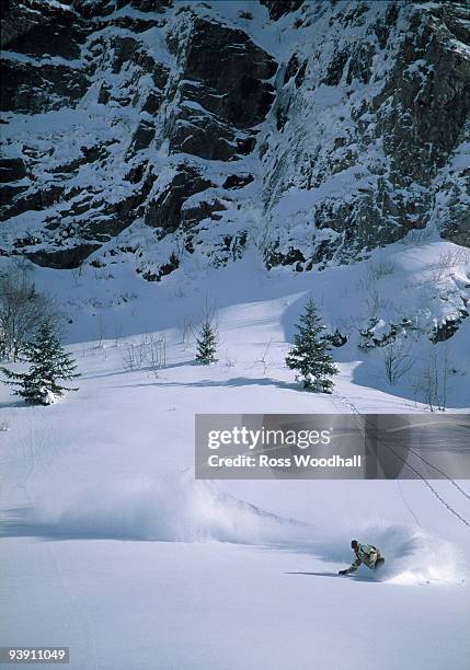 snowboarder turning in powder snow - ross woodhall stock pictures, royalty-free photos & images