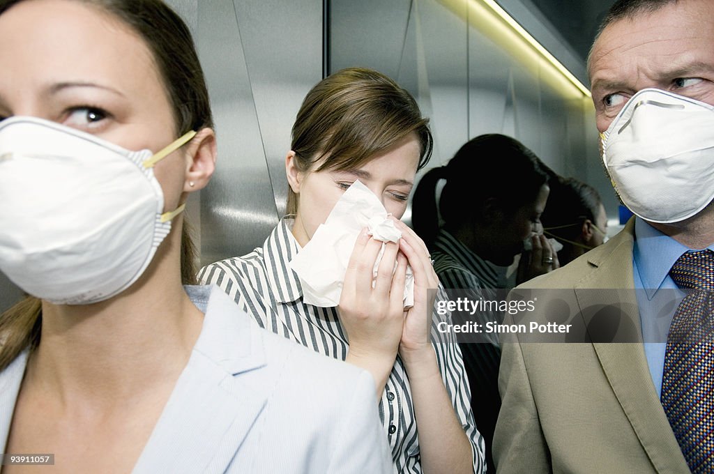 People in a lift during a health alert