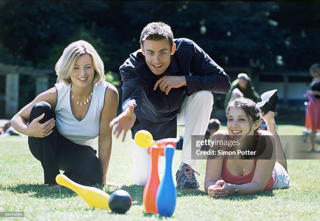 A group of friends playing skittles