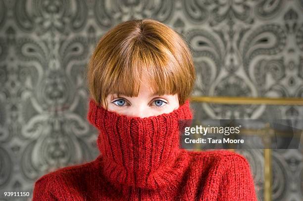 woman with jumper pulled over face - shy stock pictures, royalty-free photos & images