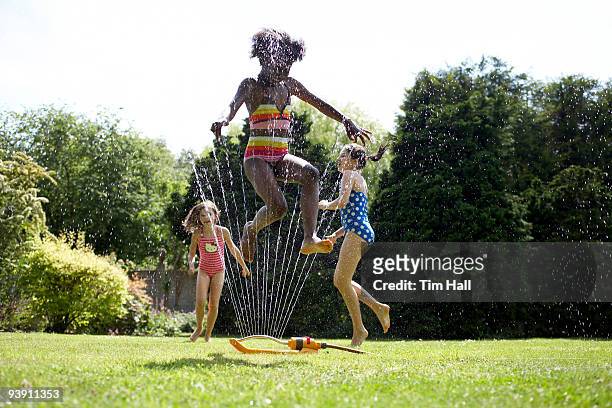kids in garden - black girl swimsuit stock pictures, royalty-free photos & images
