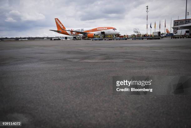 An Easyjet Plc passenger jet stands on the tarmac as the budget airline announces a new summer flight schedule at Tegel airport, operated by...