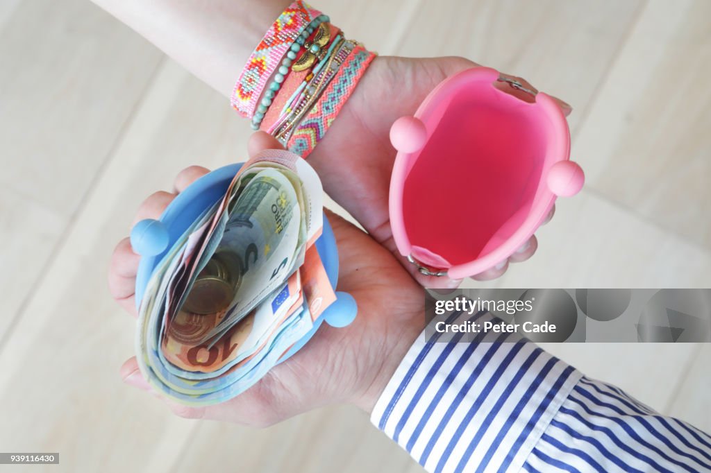 Money in mans wallet, empty womans wallet